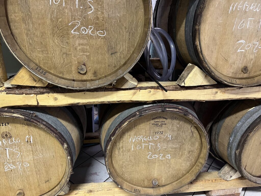 Barrels of Nerello Mascalese marked in chalk in the cellar